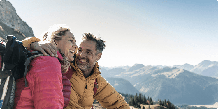 Happy couple hiking mountain